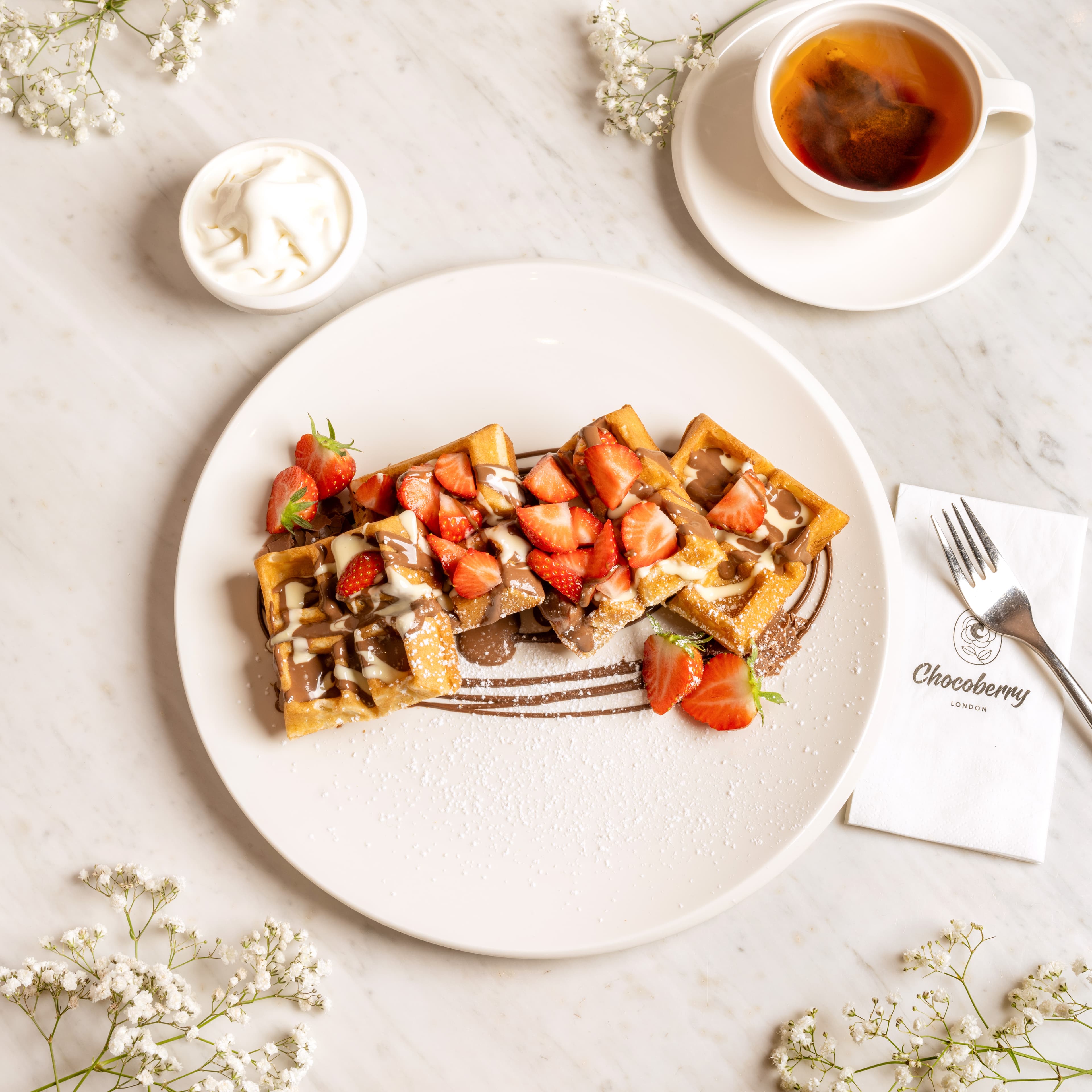 Chocoberry signature Belgian waffles on marble table